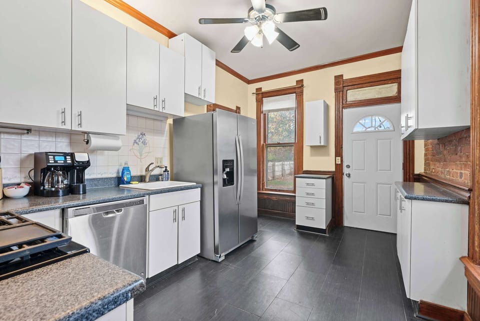 The airy kitchen offers ample space & every home comfort