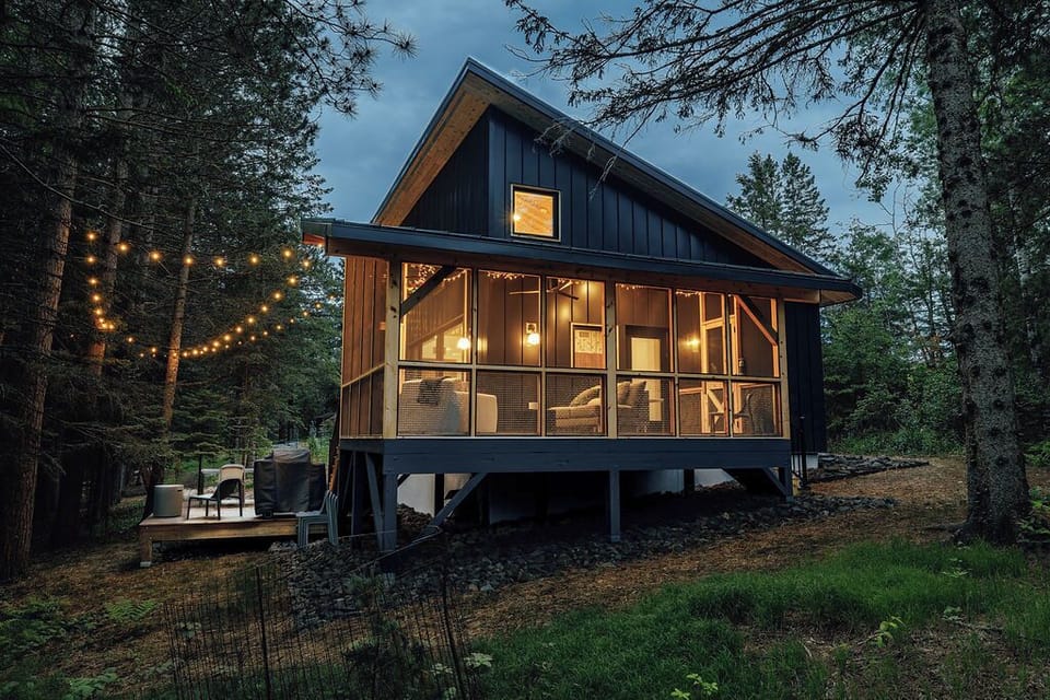 String lights lead the way to between your cabin and treehouse. Enjoy evening light on a private deck and a fully covered screen porch.