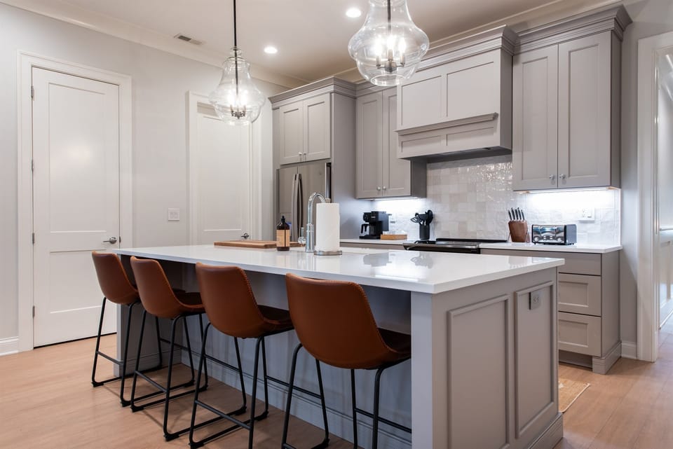 This modern kitchen, with its spacious island and stylish bar stools, is perfect for bourbon trail travelers. Share stories, enjoy local spirits, and prepare meals in this inviting space, designed 