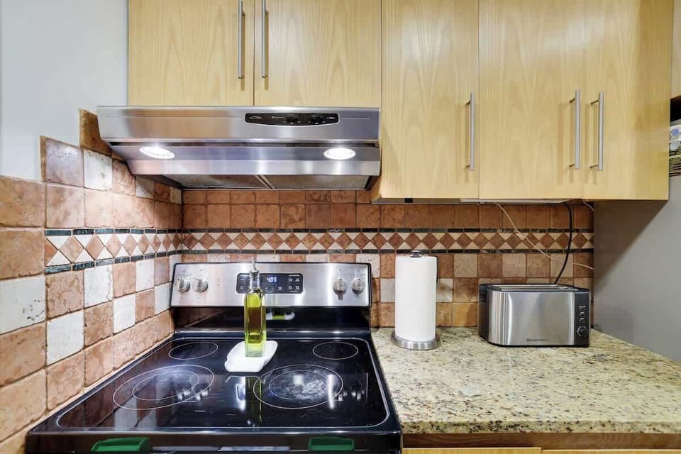 Whip up your favorite dishes effortlessly with the high-performance stove in our fully equipped kitchen.