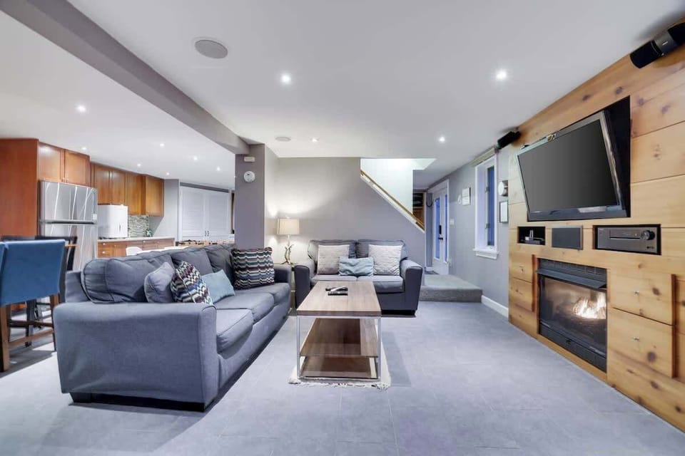 Spacious living room features plush sofa, adorned with cozy throw pillows