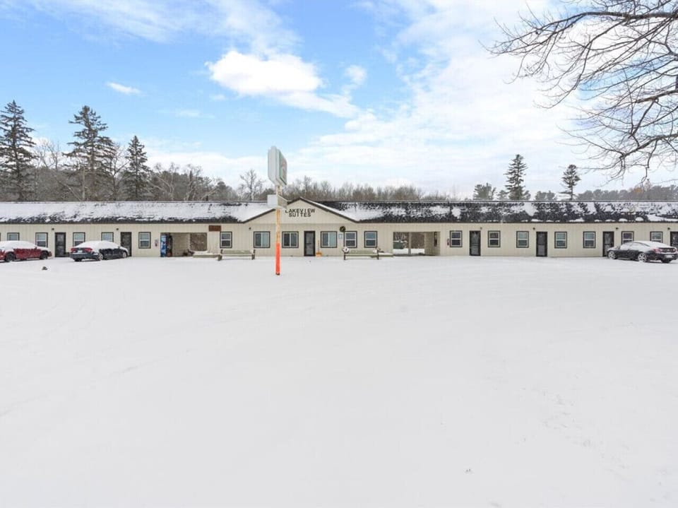 Boutique property building offering street-level entry and snow-covered surroundings.`