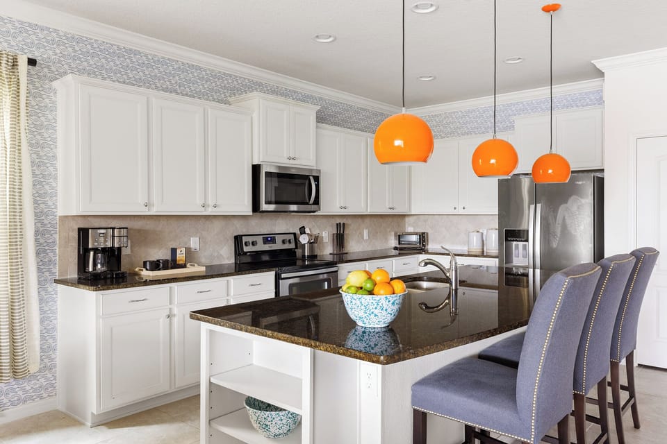 Modern chef's kitchen - equipped with a 4-burner electric stove, dishwasher, microwave, blender, and toaster oven.