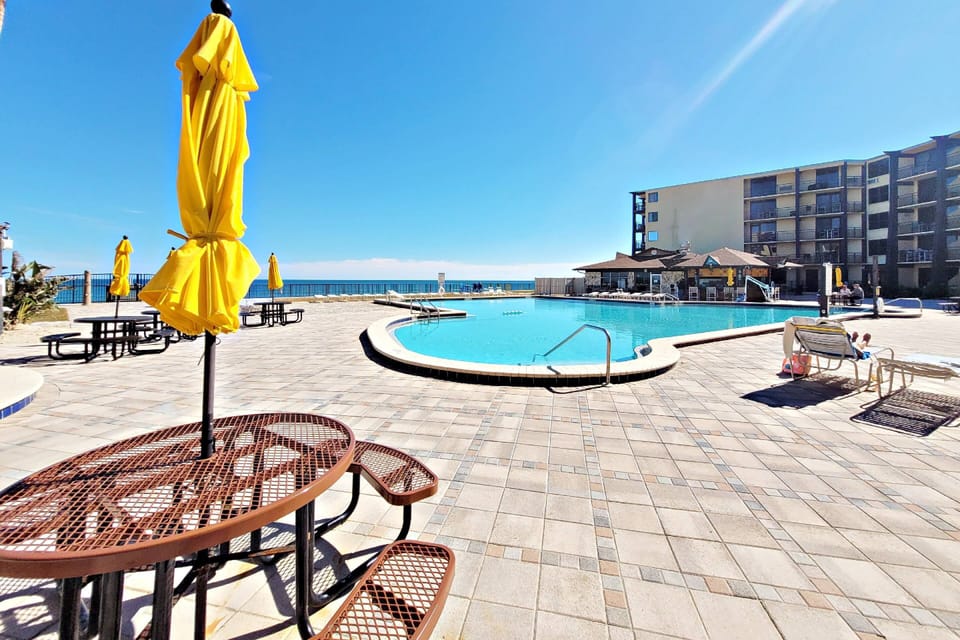 Lounge chairs and picnic table with umbrellas for your use.