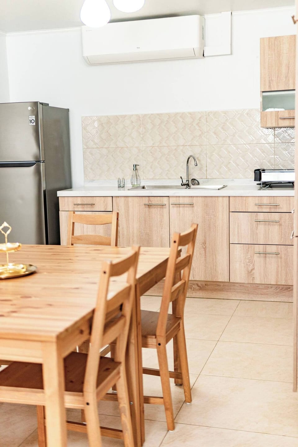 A welcoming dining table for meals with family or friends, set against a modern kitchen backdrop.