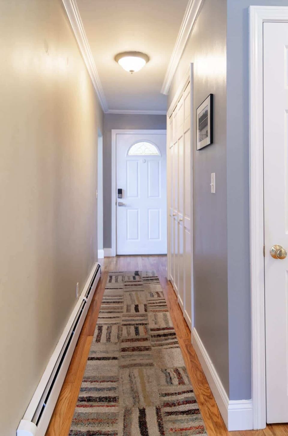 "Bright entryway with clean, welcoming lines and modern touches."