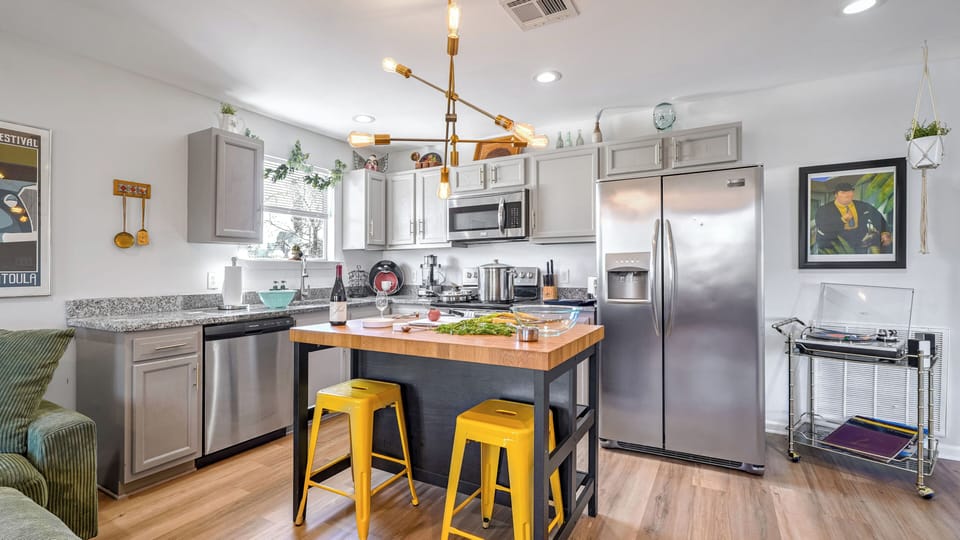 Fully equipped kitchen with a dishwasher, coffee, sugar, creamer, and filtered water