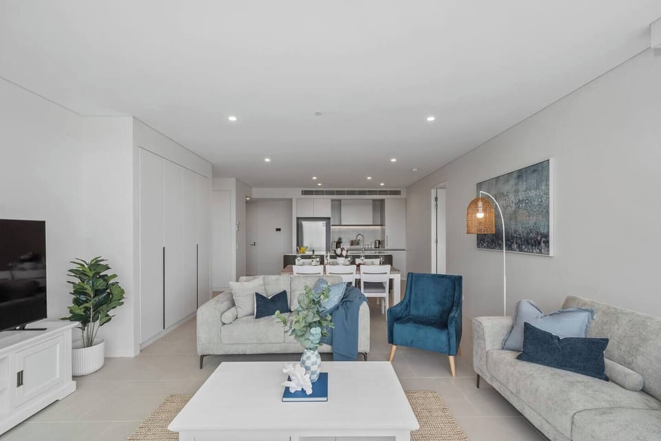 The bright and spacious open-plan living area seamlessly connects the dining space and modern kitchen for effortless entertaining.