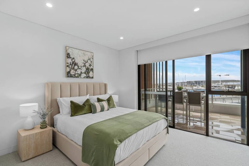 Wake up to beautiful marina views from the primary bedroom, complete with private balcony access.