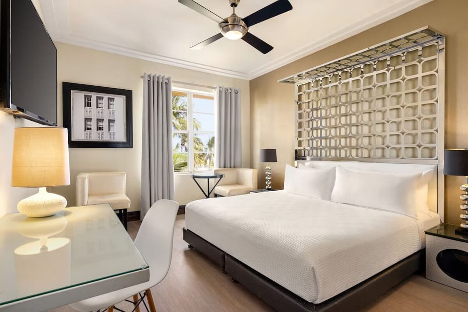 Relax in a sunlit bedroom with palms outside your window.