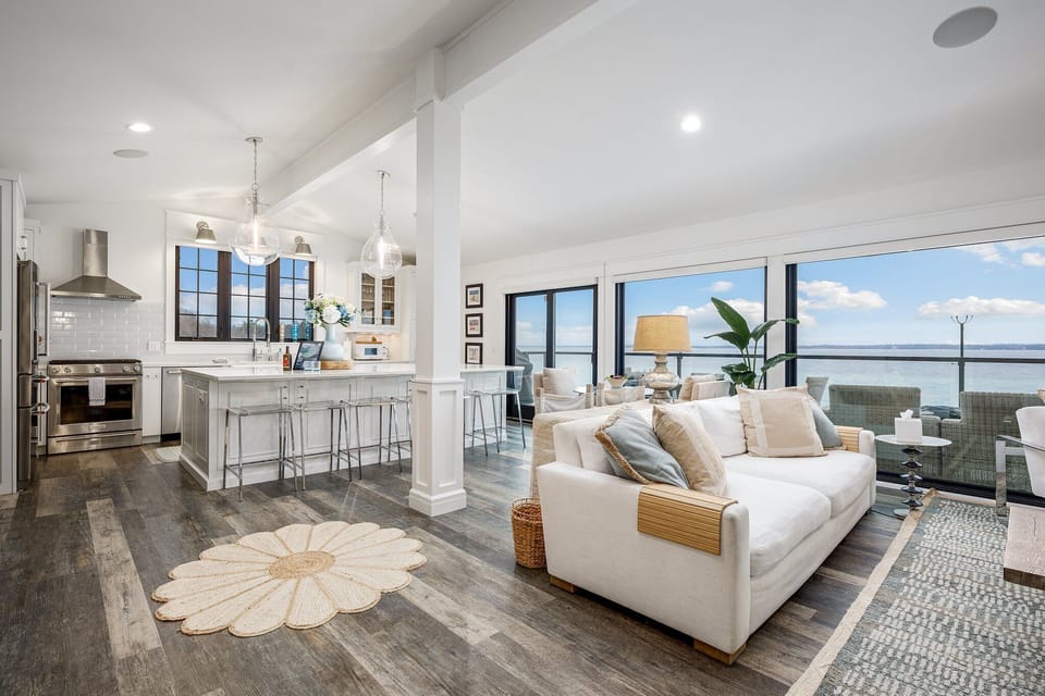 Sun-drenched coastal living at its finest. This open-concept house boasts stunning lake views, a modern kitchen, and a cozy living area, perfect for relaxing and entertaining. Imagine waking up to this every day!
