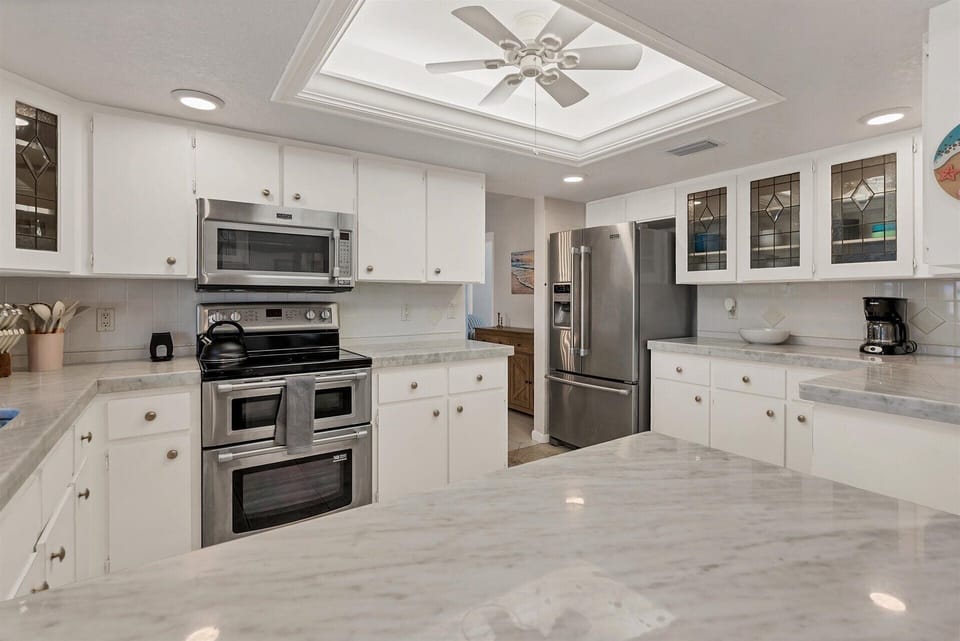 Bright, fully-equipped kitchen with plenty of countertop space and new stainless-steel appliances