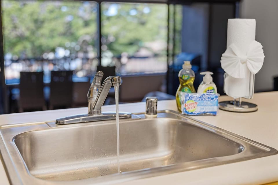 Bright and inviting, this kitchen countertop offers a glimpse of your private lanai and lush greenery, blending comfort and convenience.