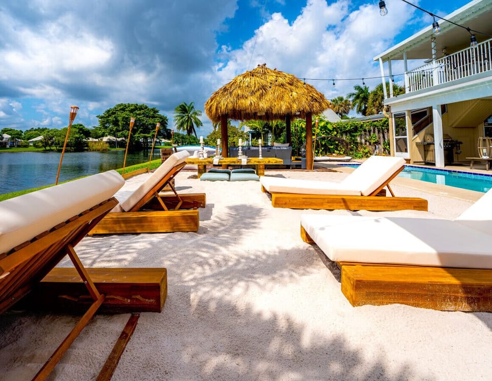 Relax on a private beach with a tiki bar, lounge chairs, torch-lit beach, and breathtaking waterfront views.