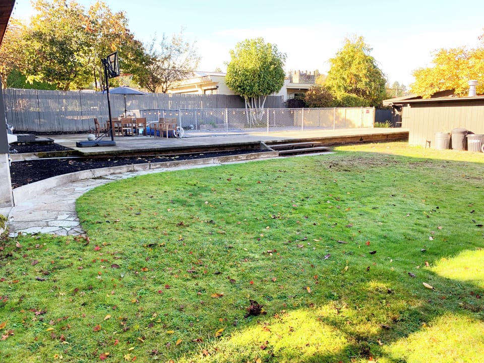 The backyard has plenty of space for kids to play and run around. 
