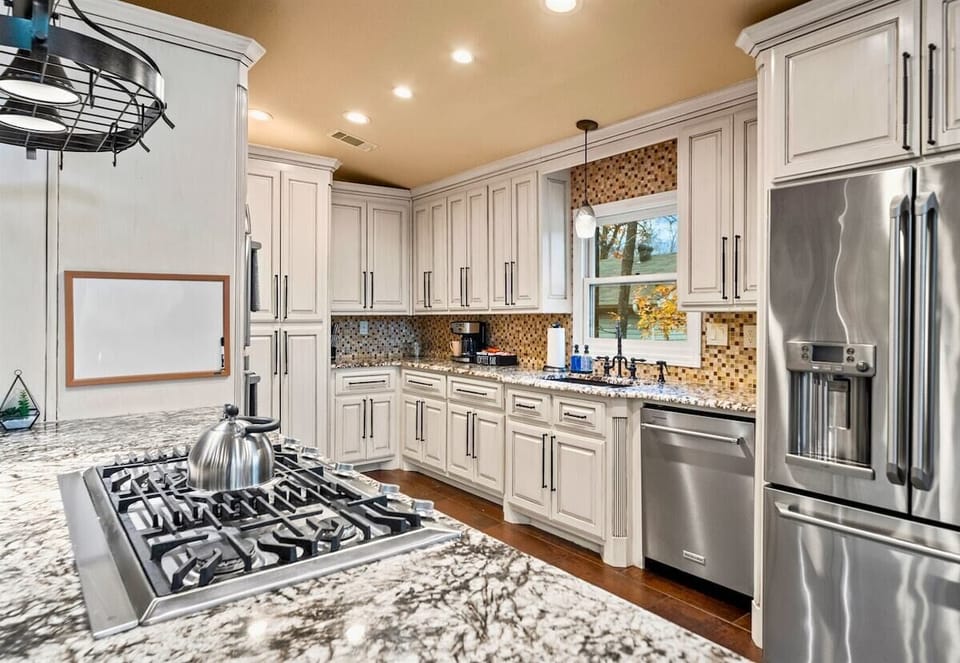 A bright and airy kitchen designed for gathering, with natural light pouring in and a layout that's ideal for everything from casual breakfasts to formal dinners.