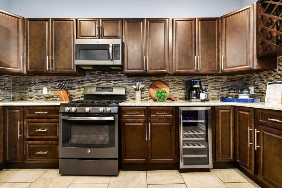 Cook with ease in this fully-equipped kitchen featuring stainless steel appliances and a wine fridge.