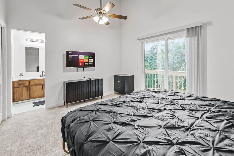 Spacious room with a king-sized bed and large windows.