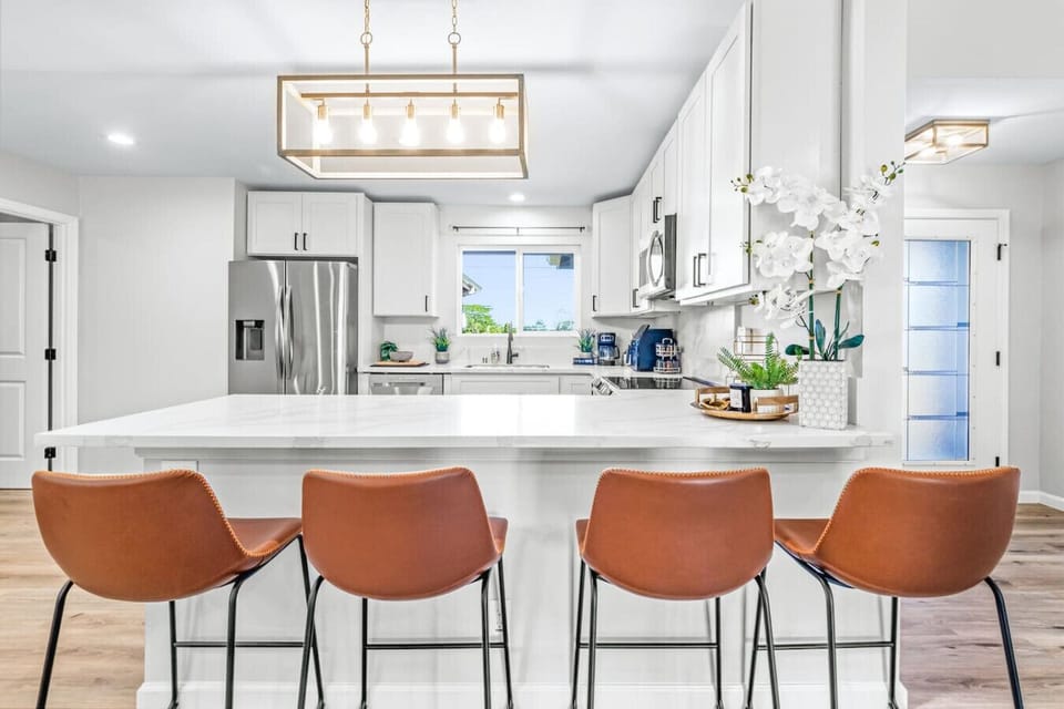 Modern kitchen with a spacious dining area and bar stools.