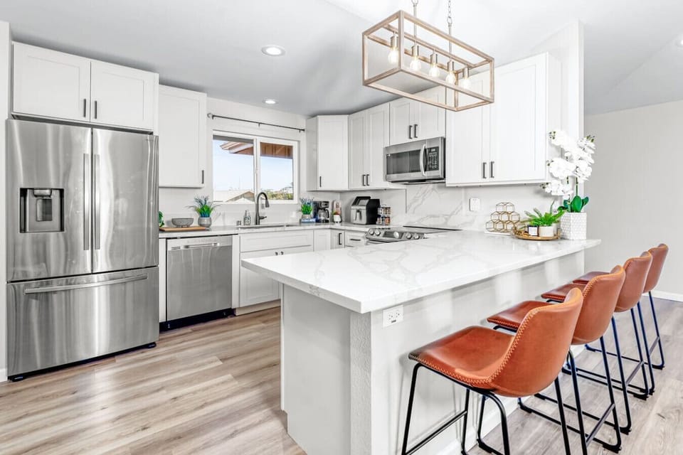 Sleek kitchen with a large island and stylish bar stools.