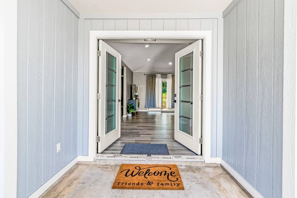 Inviting hallway with elegant doors leading to a spacious living area.