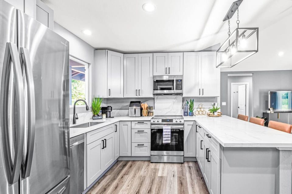 Open-concept kitchen with a breakfast bar and stainless steel appliances.