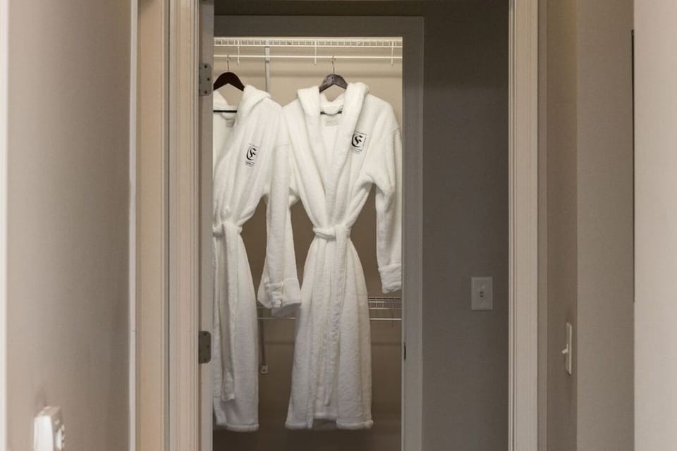 Walk-in closet with 2 fluffy hooded robes from Frette. :)