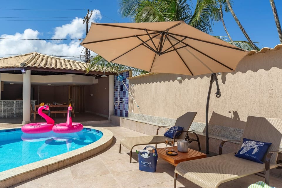 Pool area - chairs, table, umbrellas, and floaties