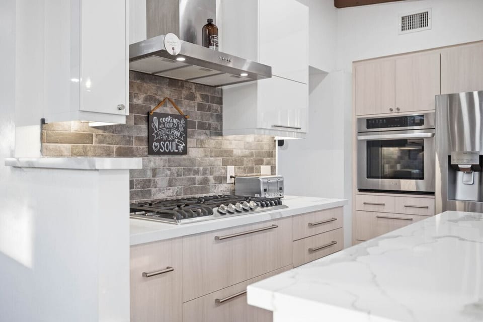 Bright kitchen with a marble island, ready for your culinary adventures.
