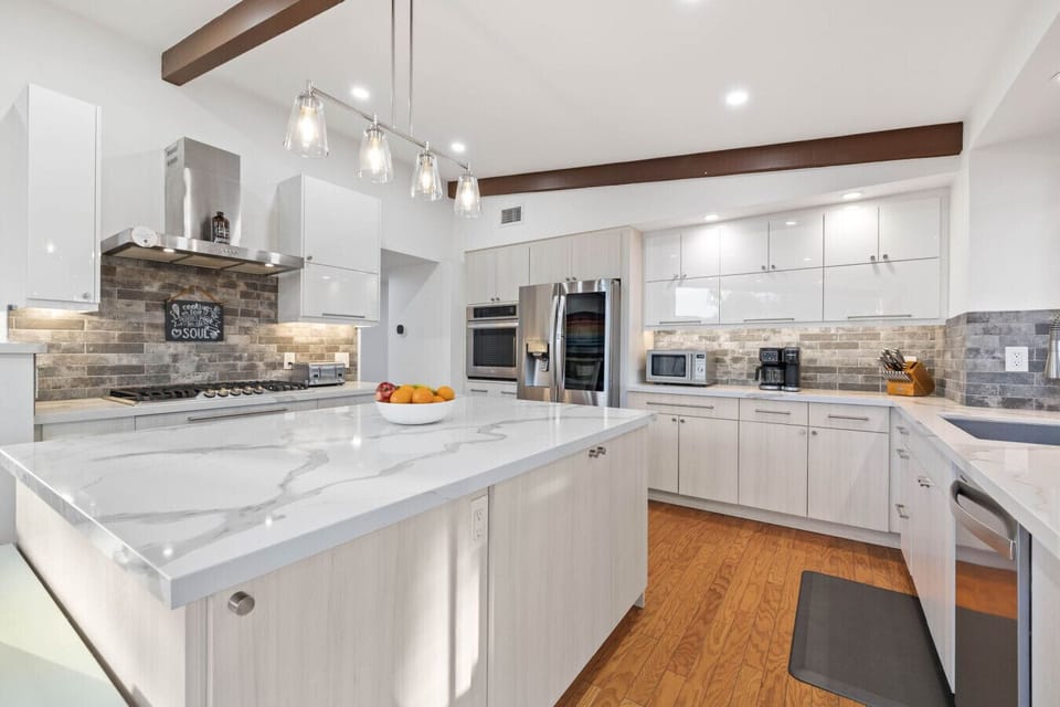 Bright kitchen with a marble island, ready for your culinary adventures.