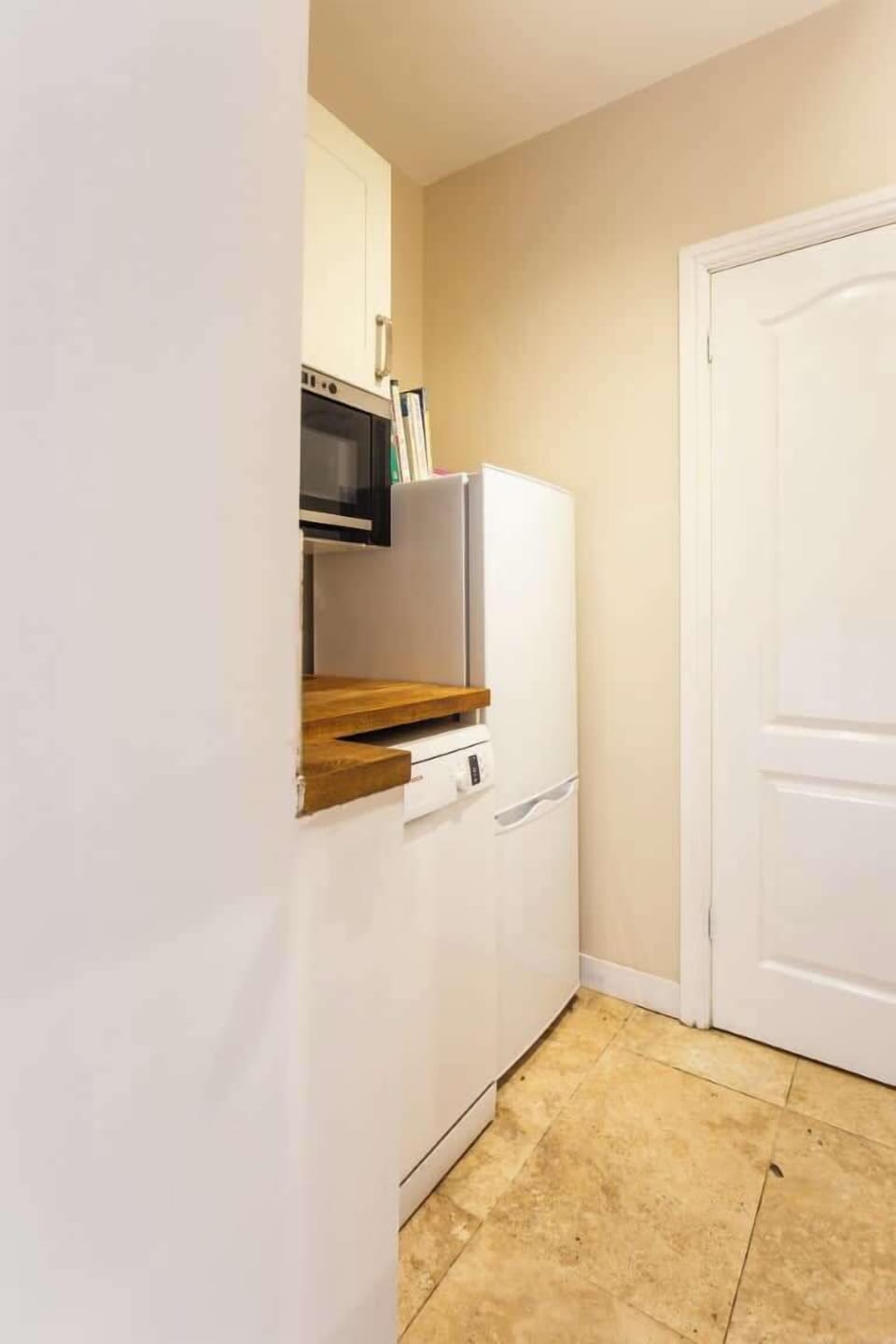 A handy utility area with Microwave, dishwasher, washing machine and Fridge Freezer
