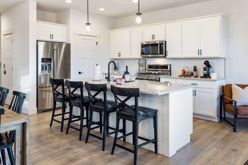Cook with ease in the fully equipped modern kitchen, featuring stainless steel appliances, a spacious island, and all the essentials you need.