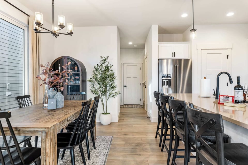 Gather in the open-concept dining area and kitchen. Enjoy meals and memories with modern amenities, perfect for families or groups.