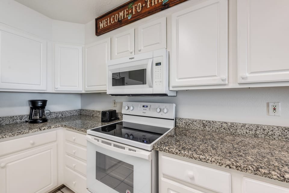 Your fully equipped kitchen welcomes you with granite countertops, modern appliances, and everything needed for home cooking.