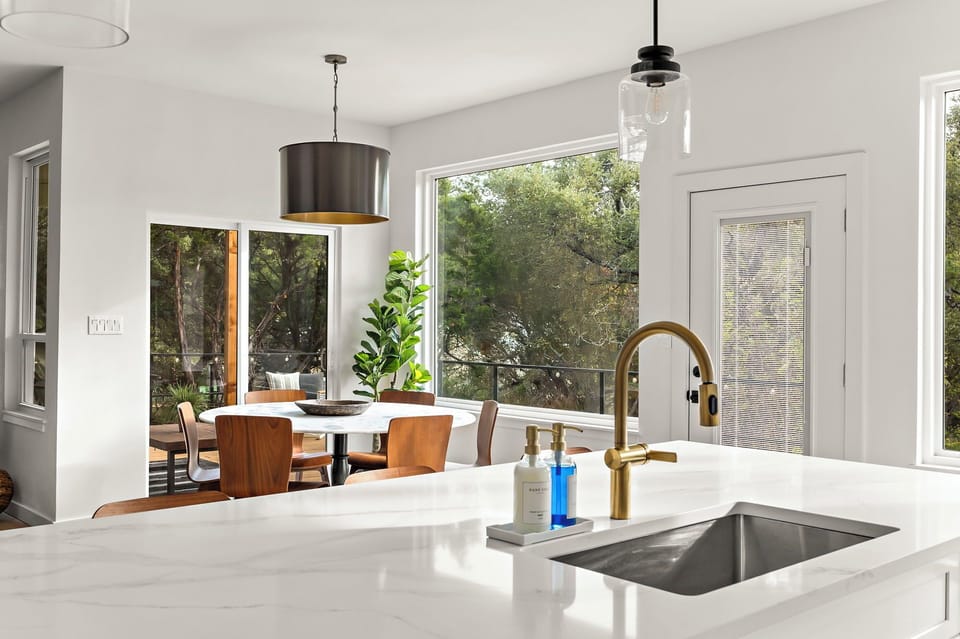 Sleek kitchen design with a bright and airy dining space.