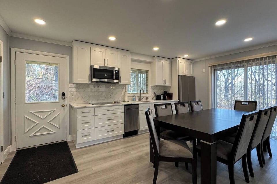 Open style kitchen with a large sliding door access to a deck