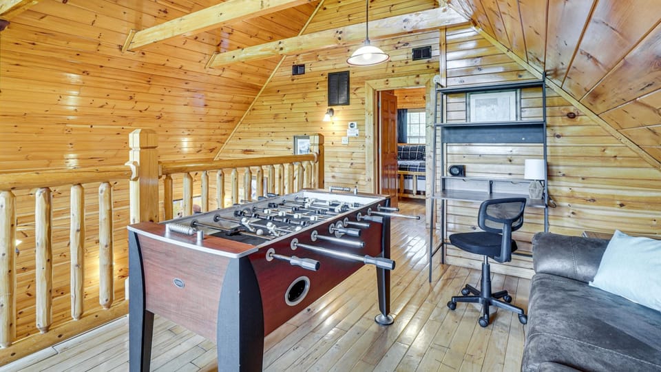Loft game space with foosball, desk, and extra sleeper sofa seating