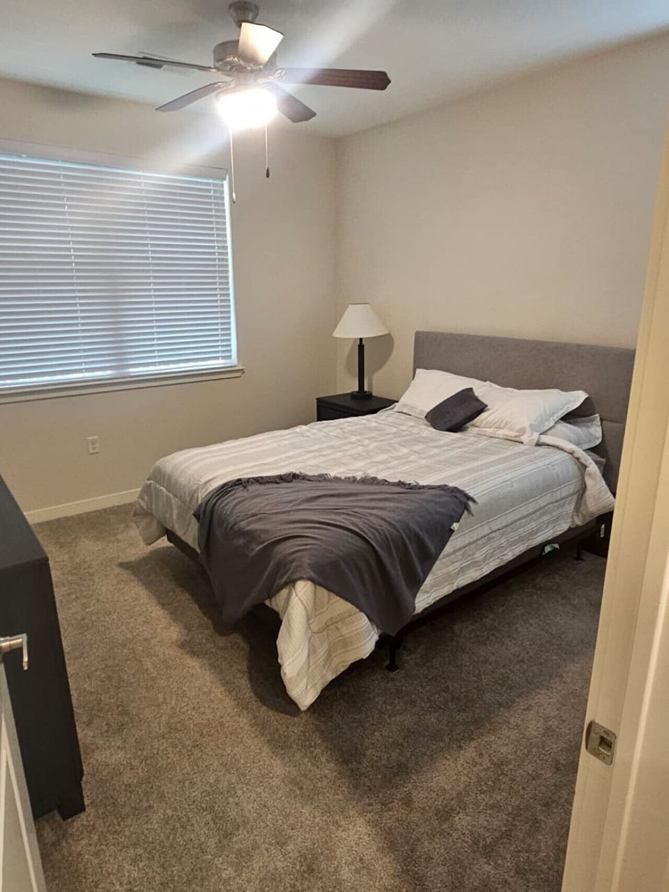 Comfortable and serene bedroom featuring plush bedding and a warm, minimalist design for restful nights.