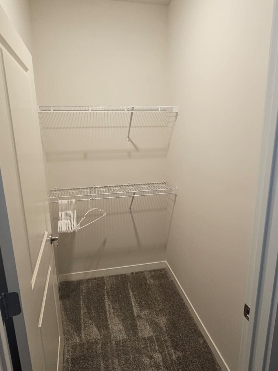 Functional walk-in closet with shelving and hangers — ideal for longer stays and easy organization.