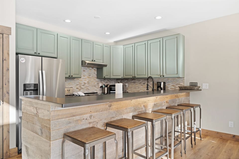 Beautiful kitchen featuring stainless steel appliances, and breakfast bar seating for 6.