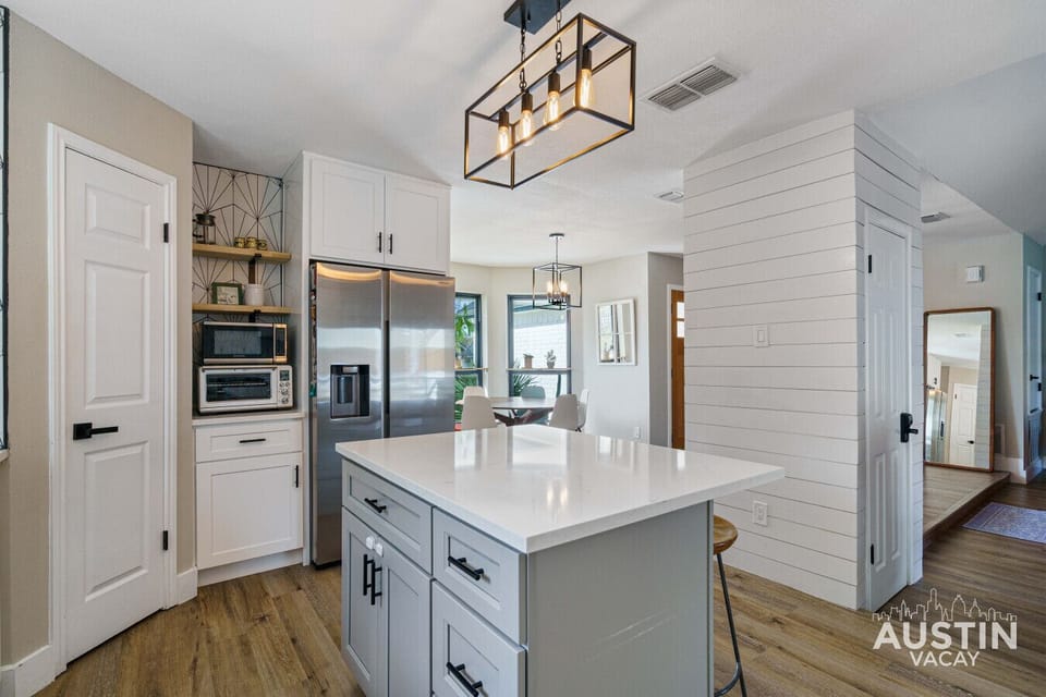 From the sleek countertops to the modern lighting, this kitchen is both beautiful and functional. The large island provides ample space for cooking and entertaining, making it the perfect hub for your stay