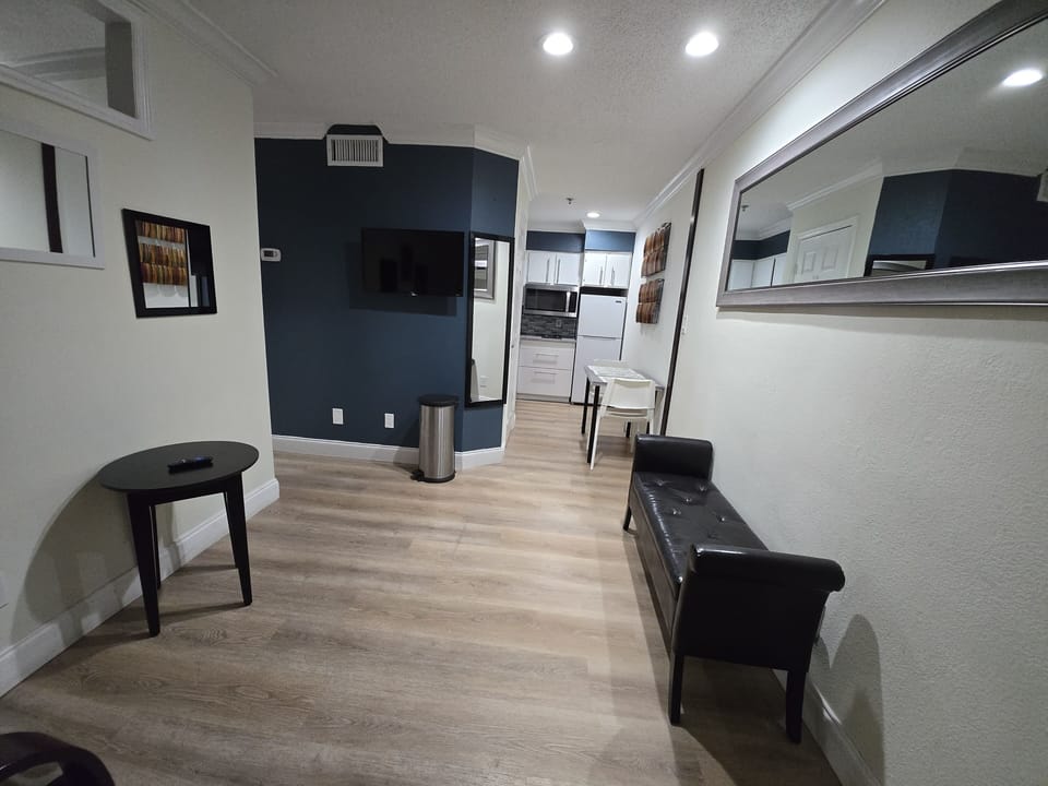 Cozy hallway lounge with a long chair and a mirror