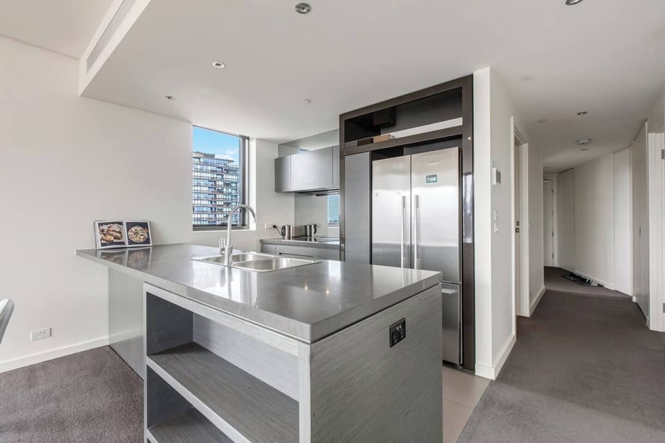 Cook with ease in the sleek kitchen, featuring stainless steel appliances and a spacious layout.