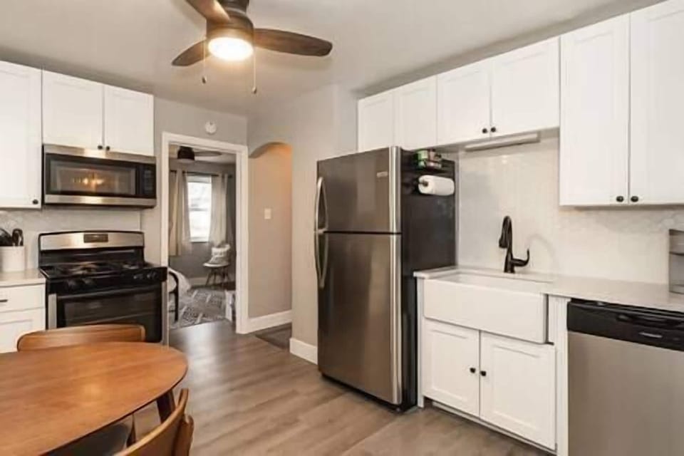 Full view of the kitchen and all appliances. The stove is a gas range.