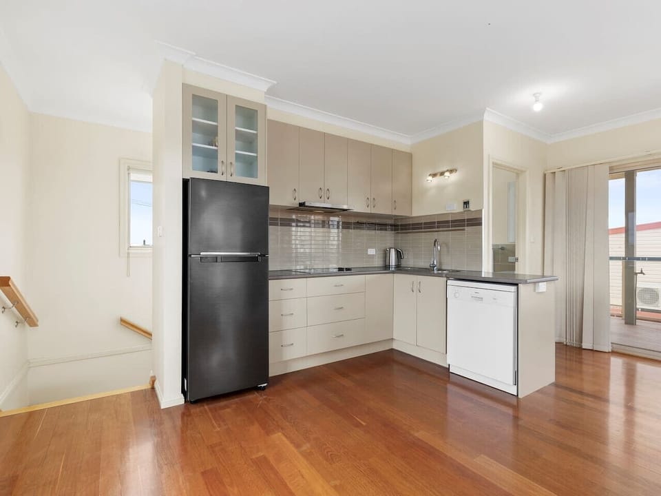 Upstairs kitchen with fridge, freezer & dishwasher