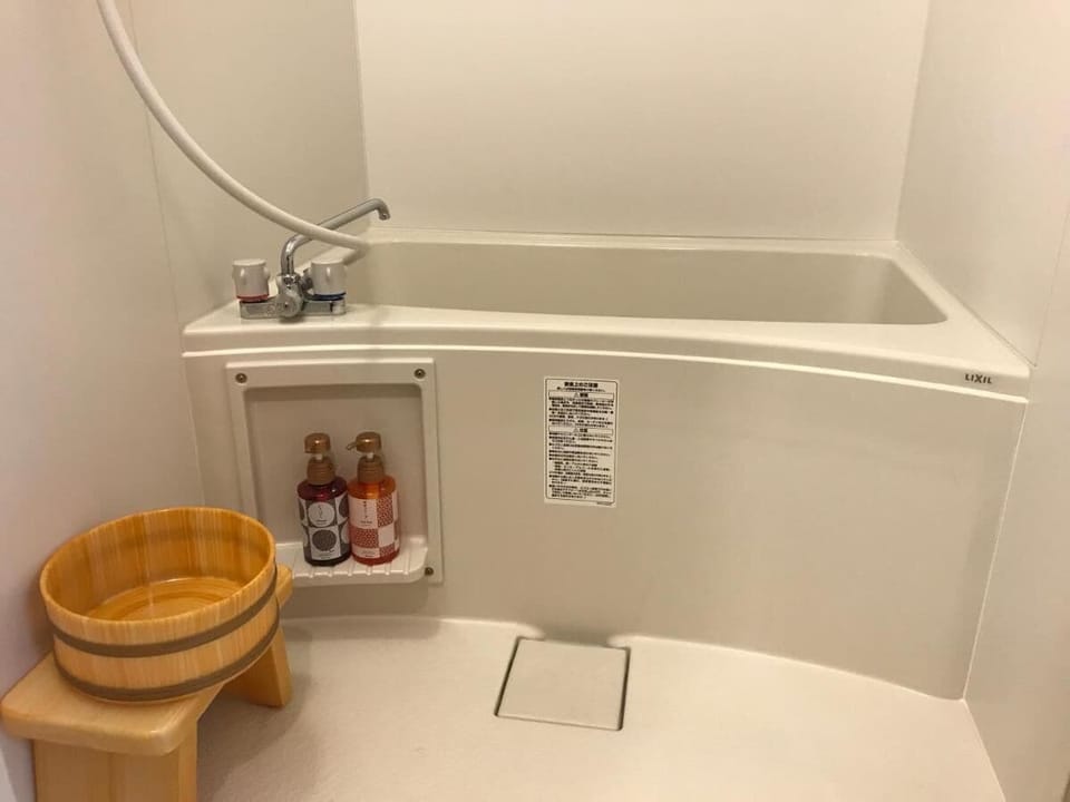 Bathtub and shower.