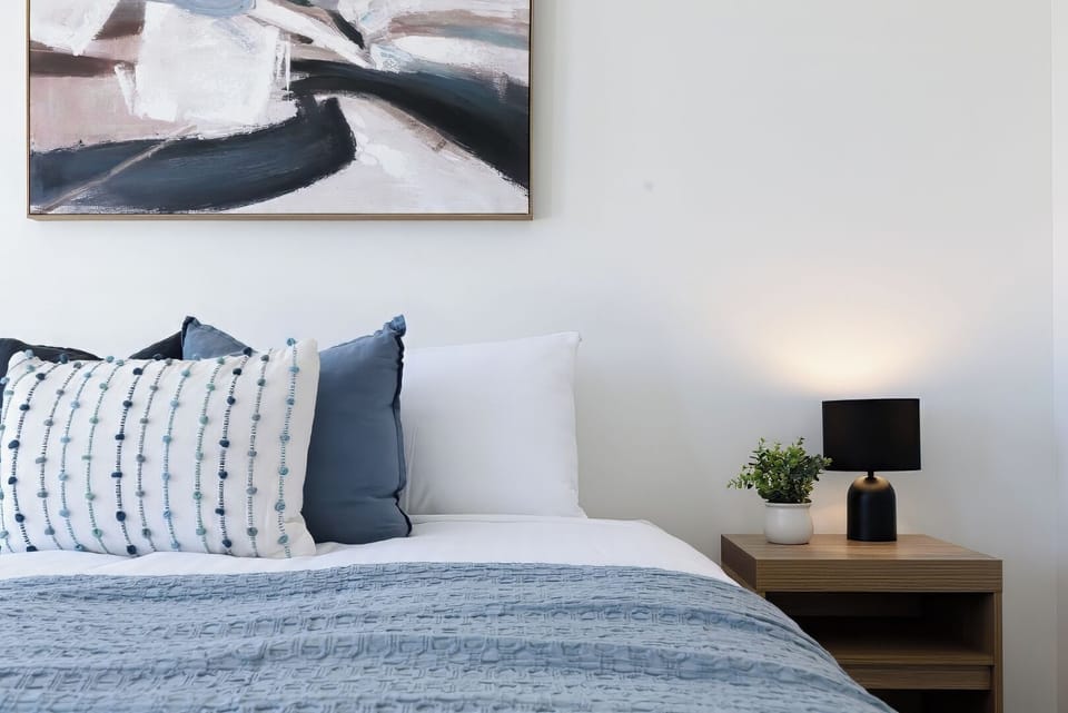 Beautiful blue king bed with abstract art