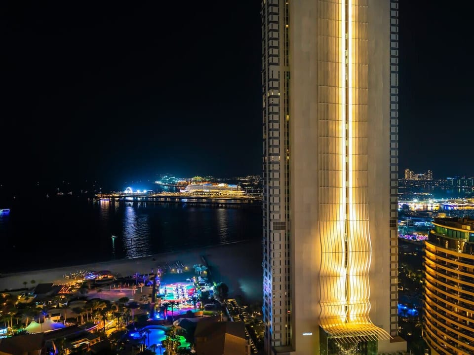 Experience the magic of JBR by night, a dazzling spectacle of city lights and serene shores.