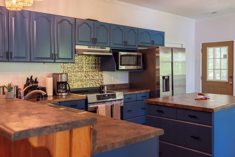 Large kitchen comes fully stocked with plenty of dishes, silverware, pots, pans, and basic spices