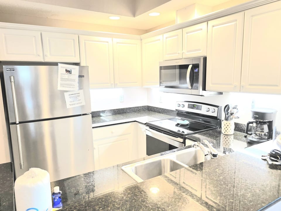 updated kitchen with granite countertops and stainless appliances